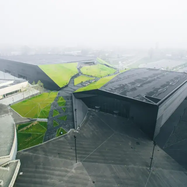 Panoramic view of the parallelepiped clad in black expanded metal mesh